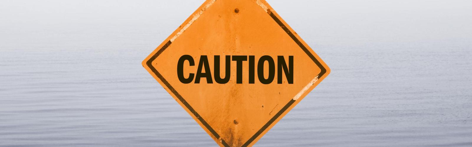 Caution Sign in water